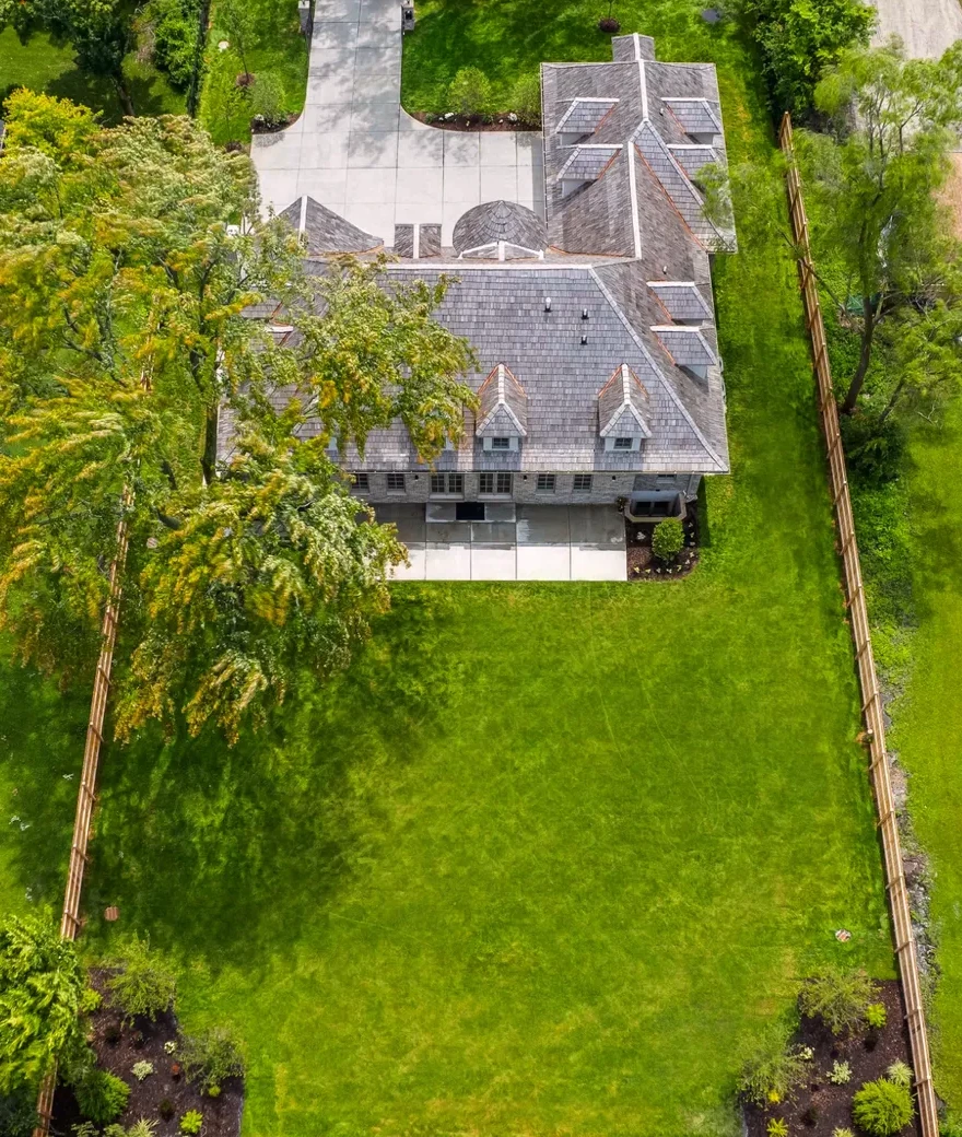 Aerial view of the residence within its tree-lined grounds